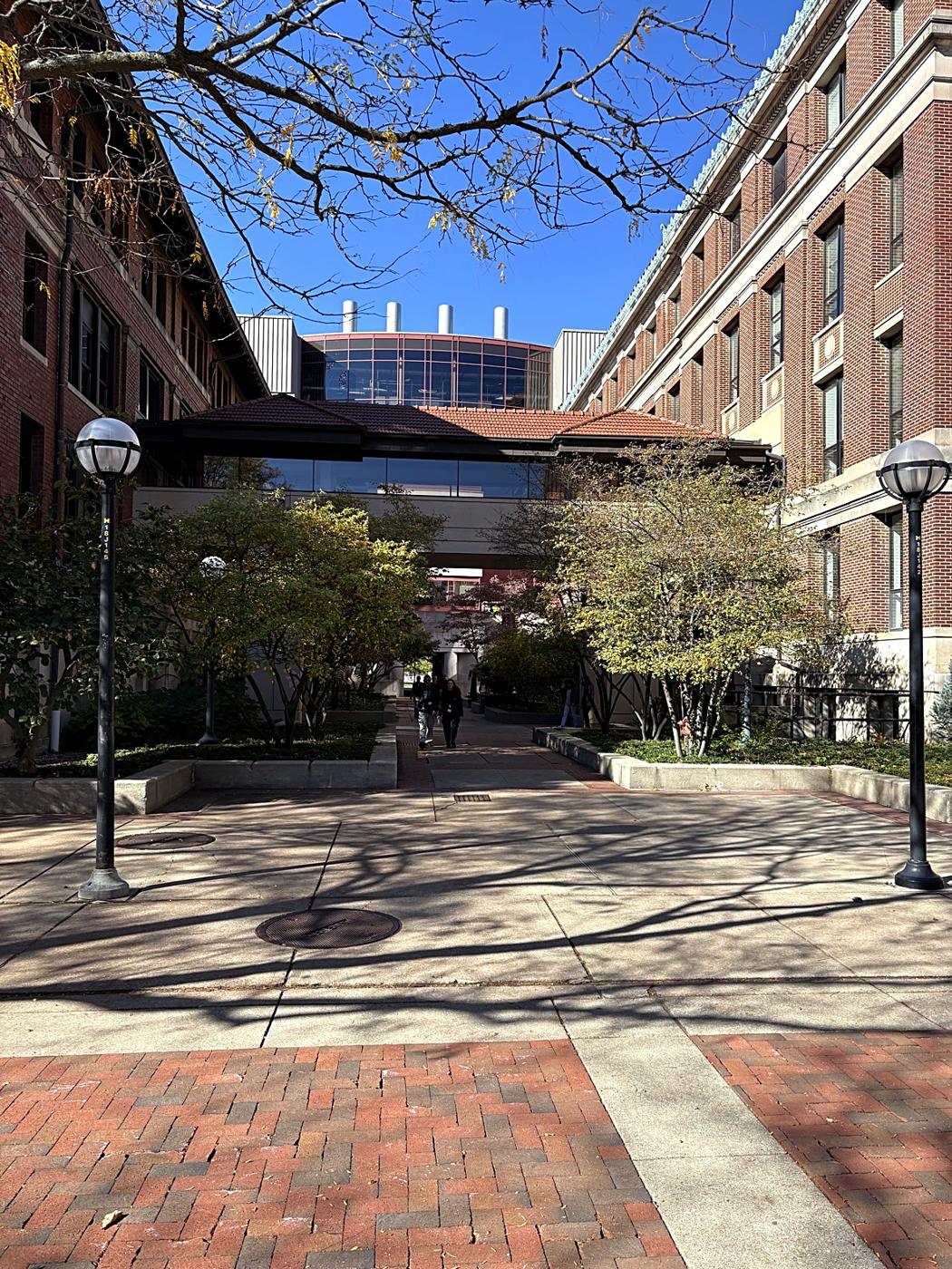 A brick courtyard and glass skybridge between University of Michigan buildings