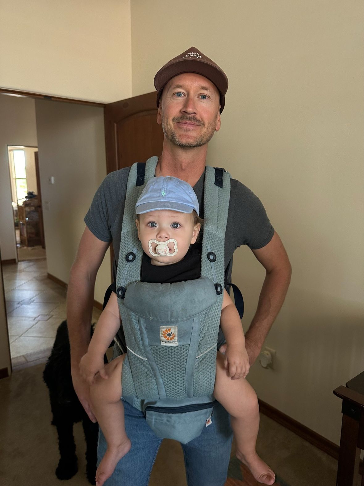 Kristian carrying his son Easton in a baby carrier