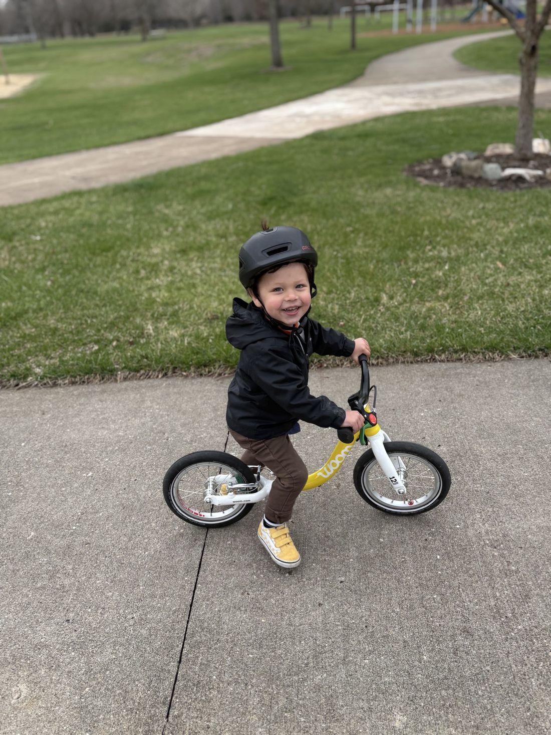 Easton on his balance bike in a park