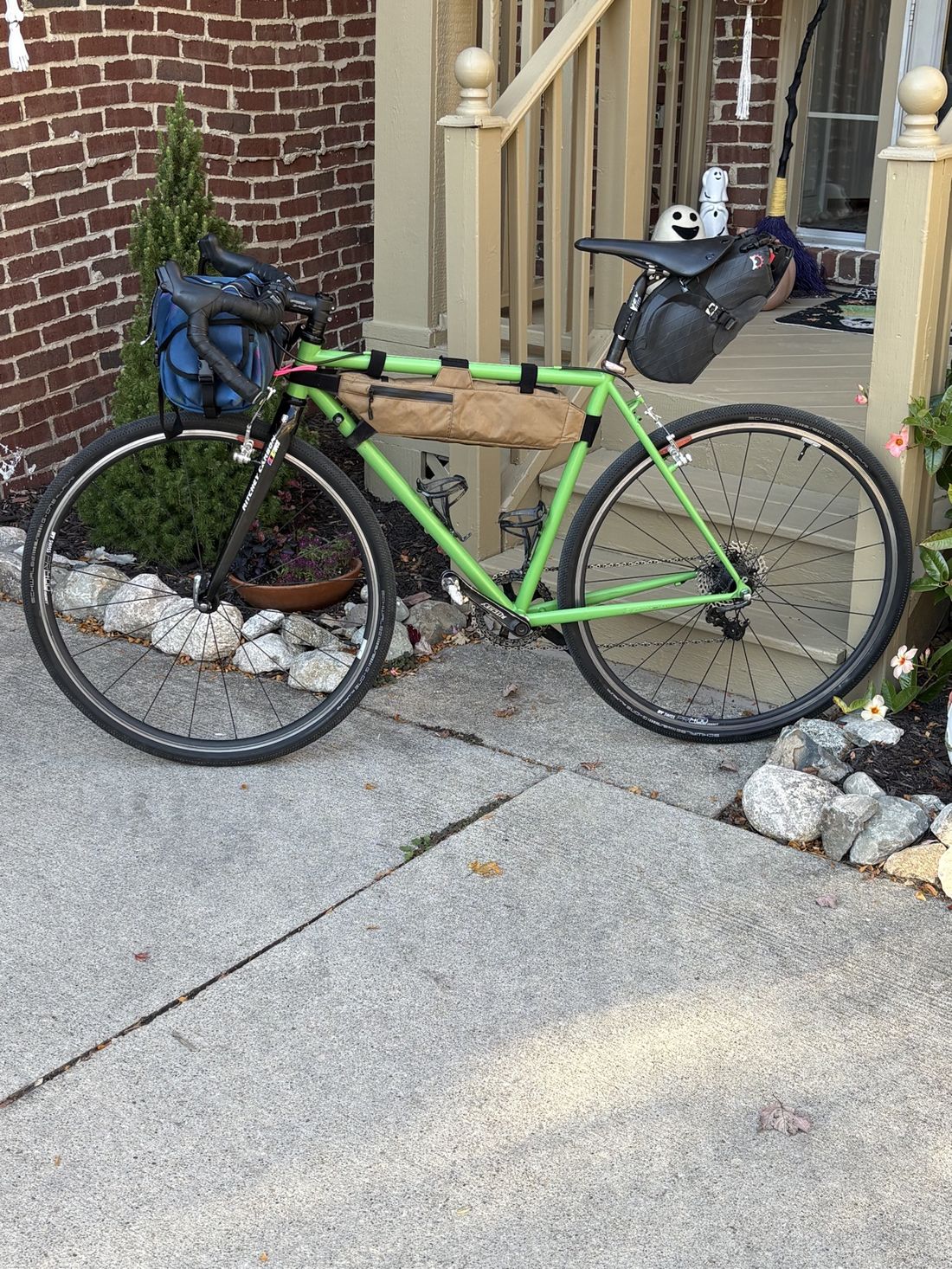 A green touring bike loaded for bikepacking