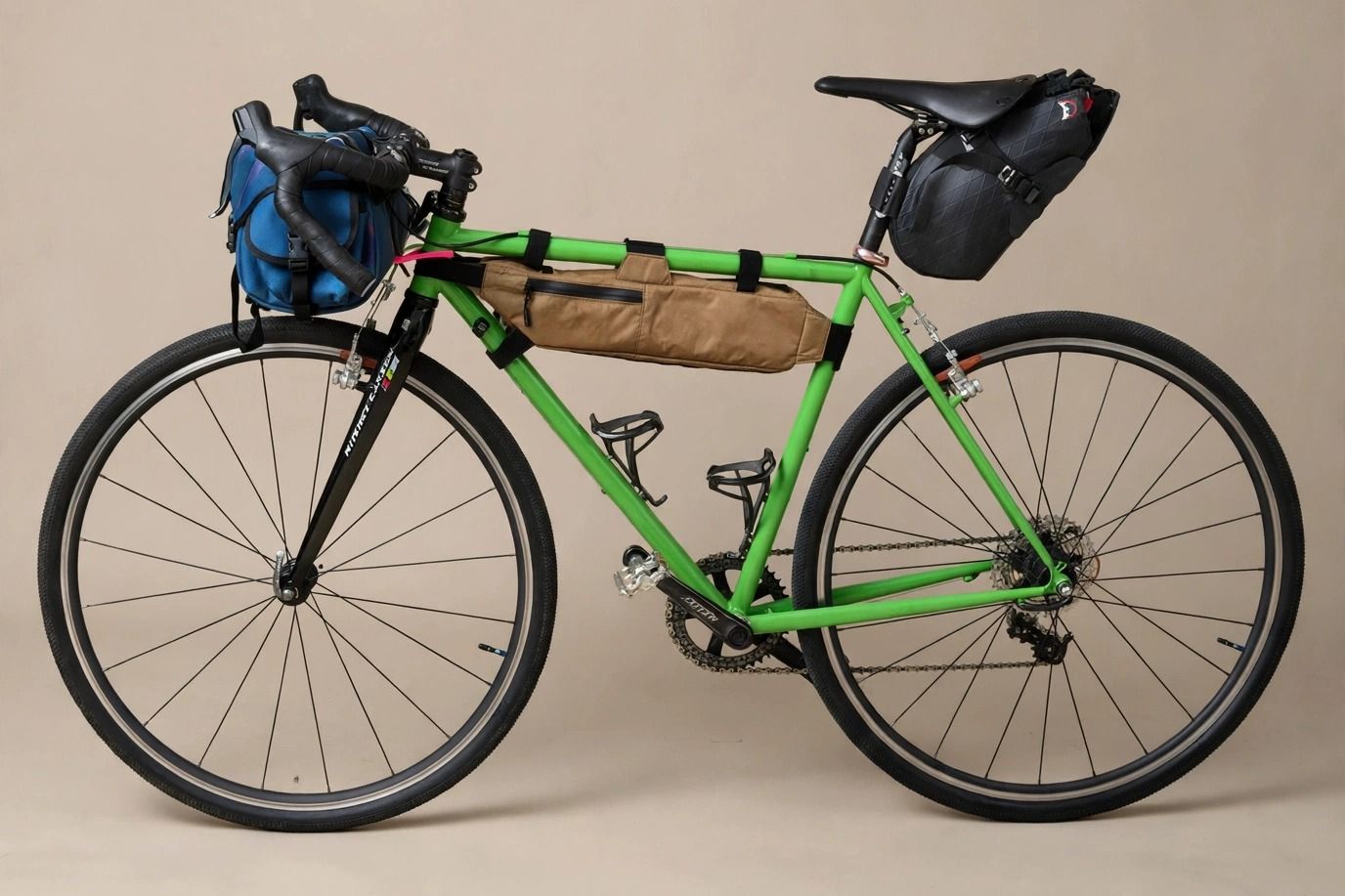 Kristian's green Gunnar, packed with bikepacking bags, in a studio photo