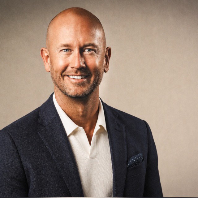 Kristian Chervenock smiling, in a navy blazer