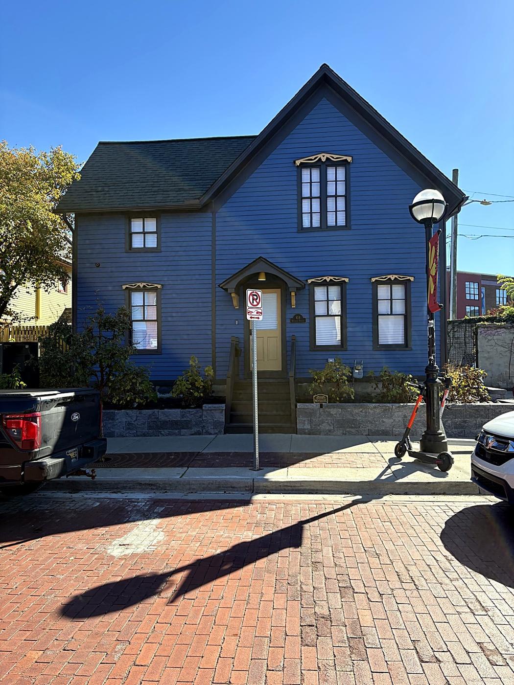 A blue Victorian house on a brick corner in Kerrytown