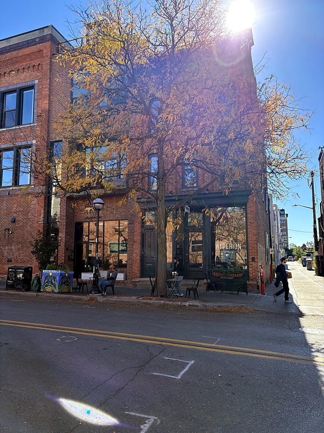 A brick corner building with Hyperion Coffee on the ground floor