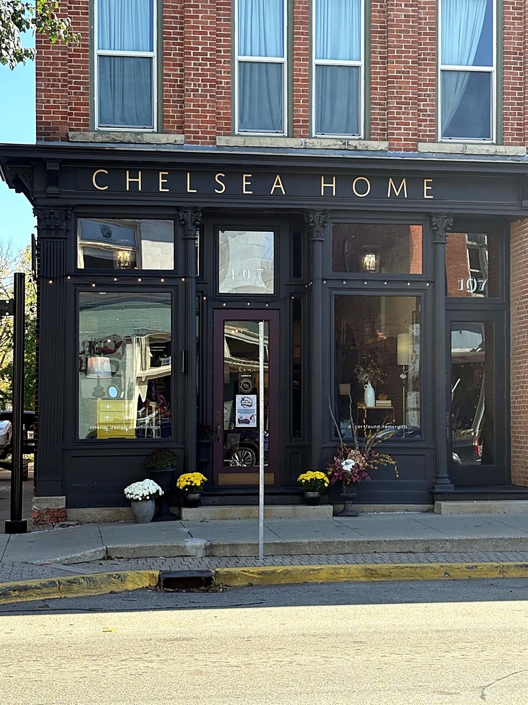 The Chelsea Home storefront with mums by the door