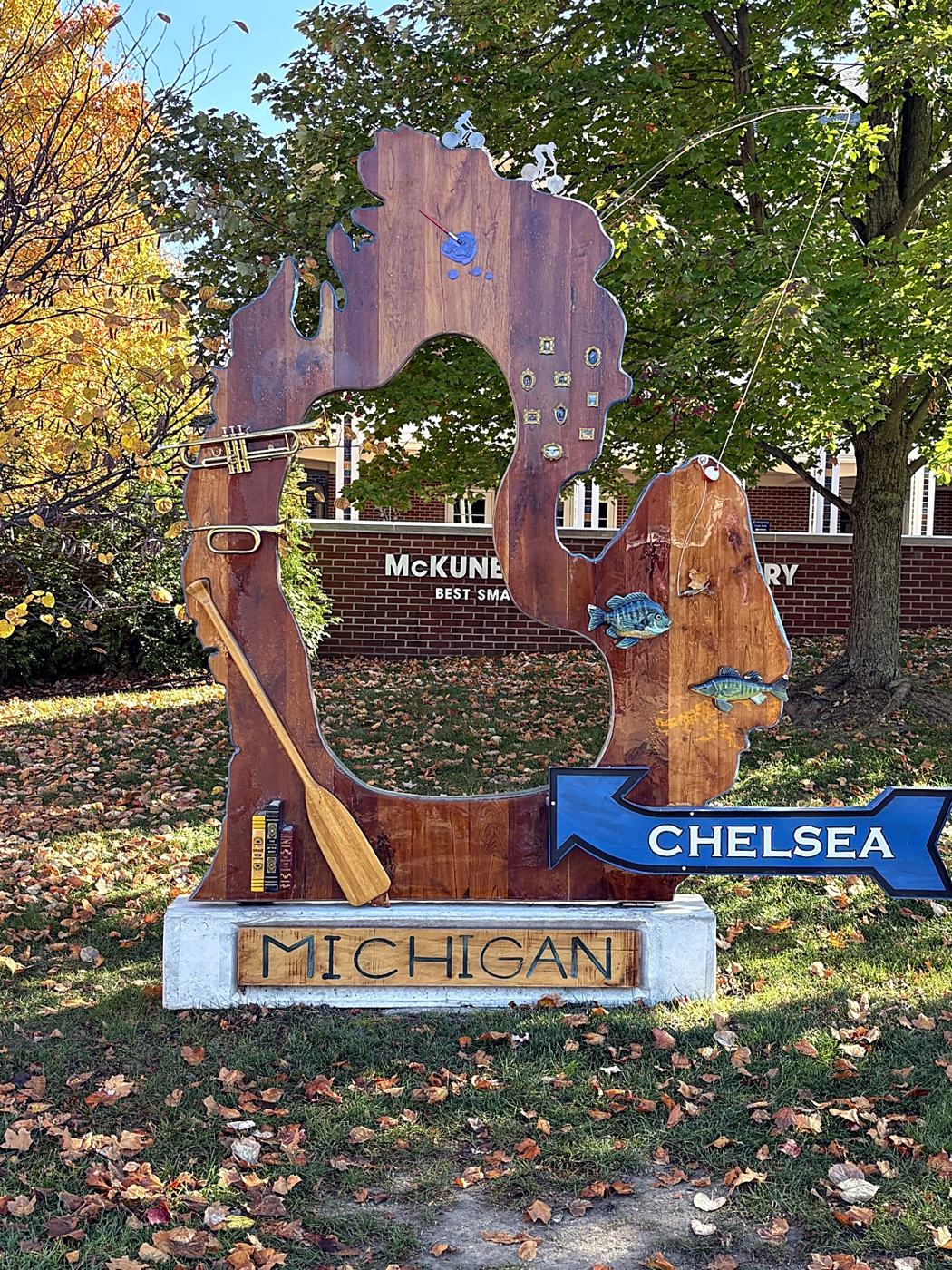The wooden Michigan sign in front of the McKune Library in Chelsea