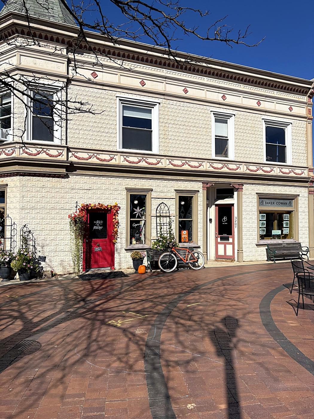 An ornate historic building on a brick plaza in downtown Dexter