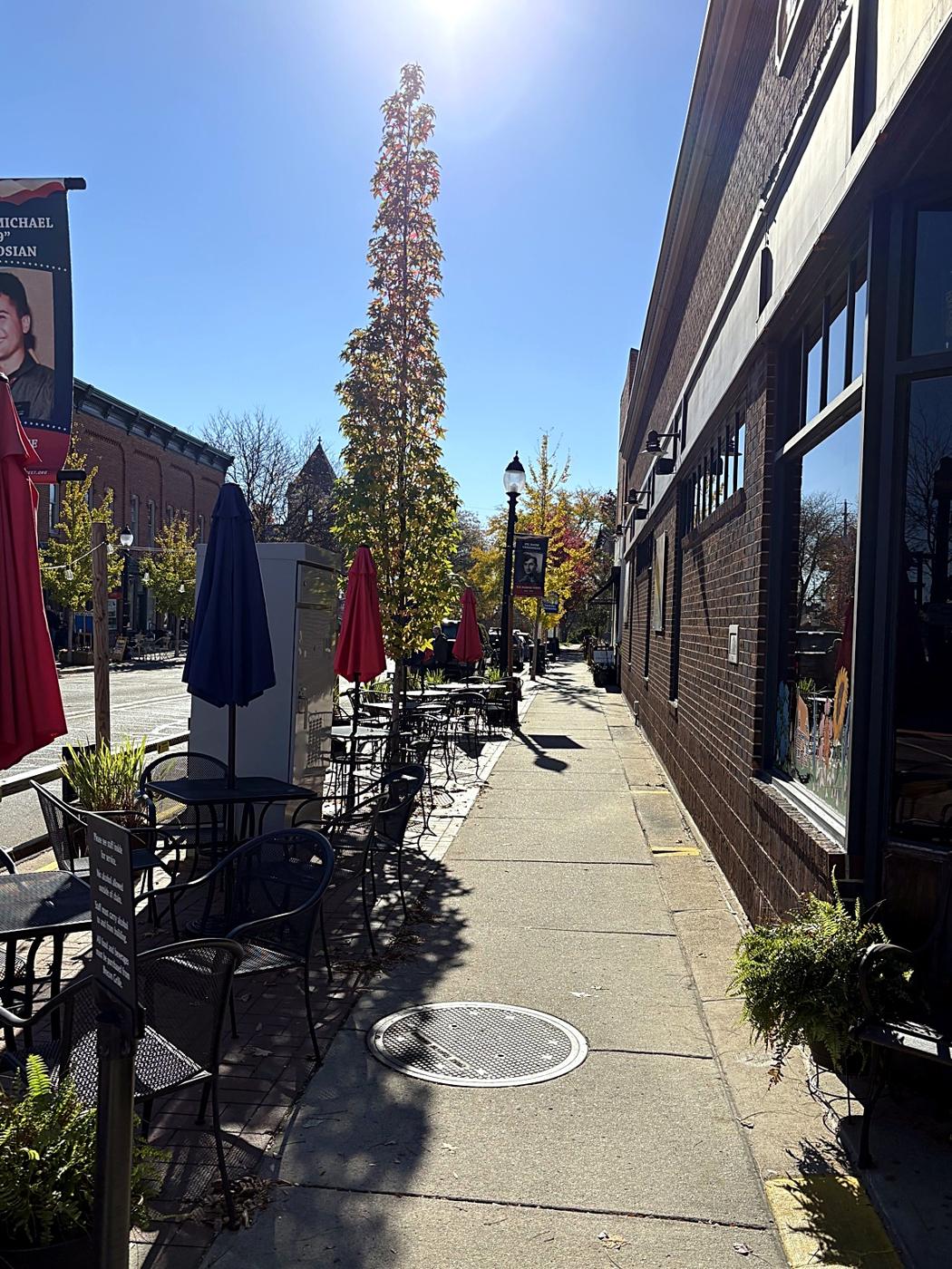 Café tables lining a downtown Saline sidewalk